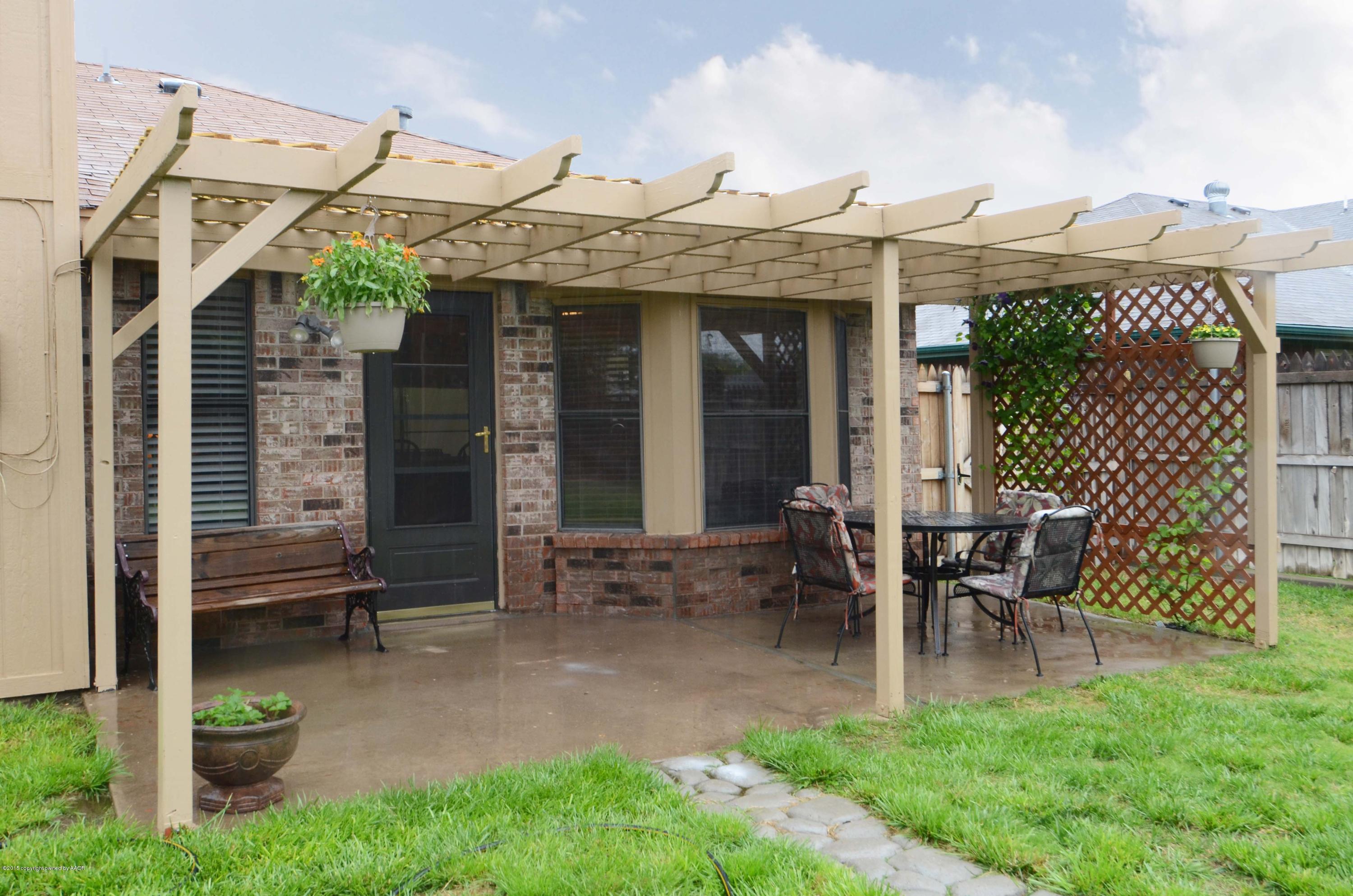 8104 Leah Trail Amarillo, TX 79110 - Photo 18 of 22 a view of a patio with table and chairs and potted plants
