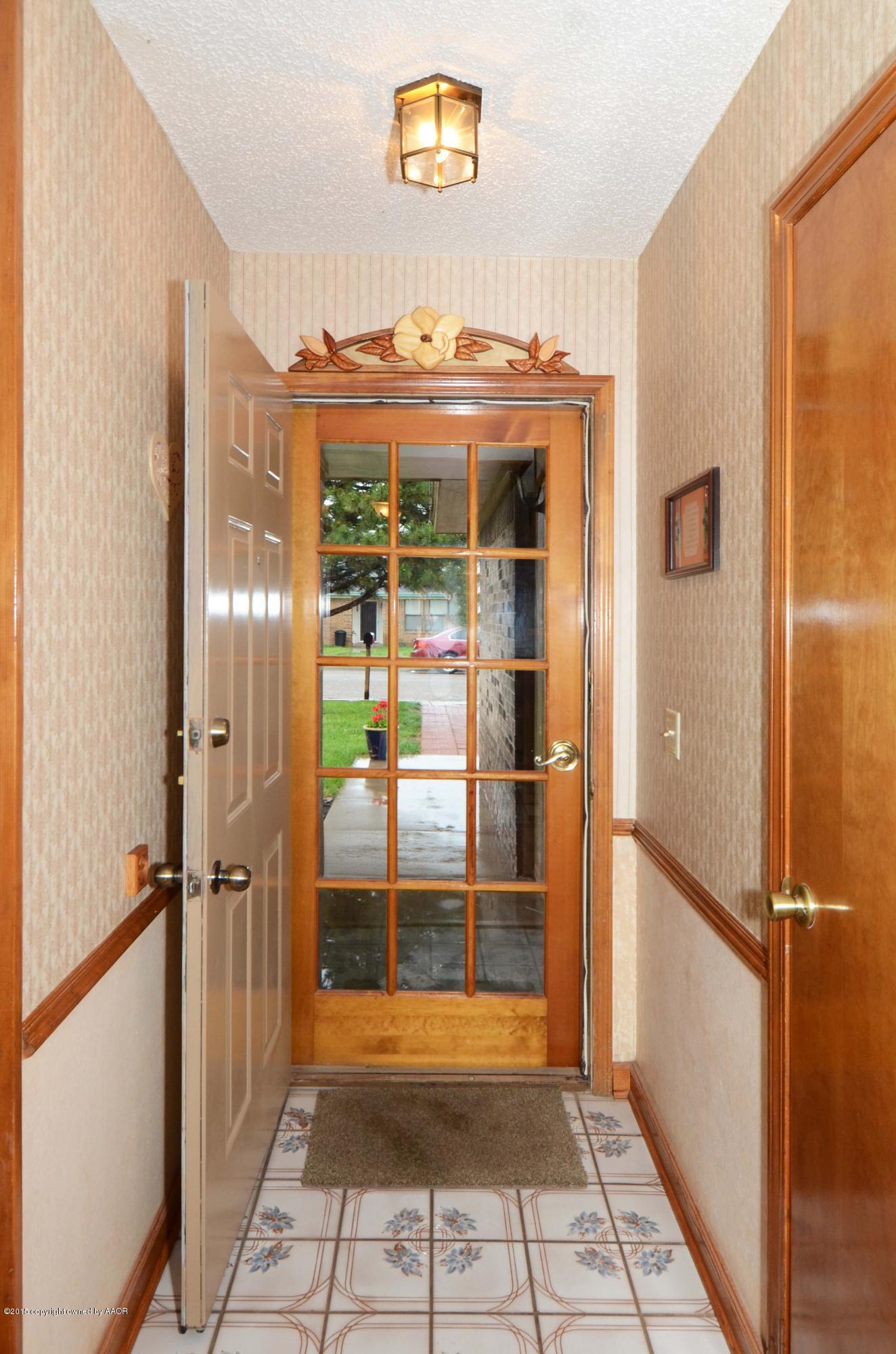 8104 Leah Trail Amarillo, TX 79110 - Photo 22 of 22 a view of a door and an empty room with wooden floor
