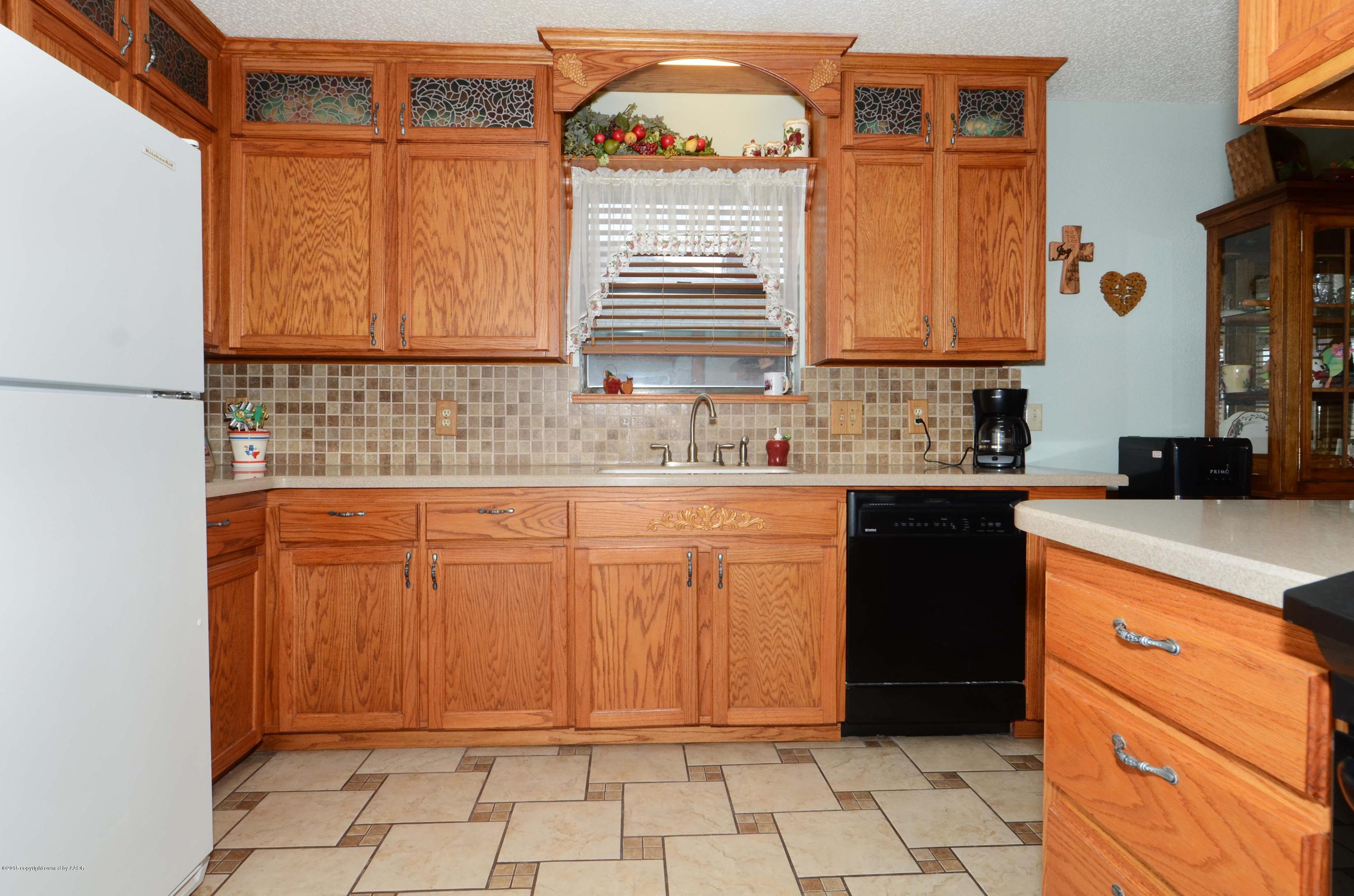 8104 Leah Trail Amarillo, TX 79110 - Photo 5 of 22 a kitchen with a sink cabinets and window