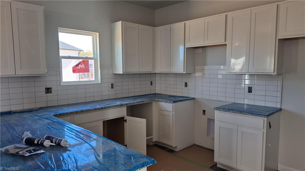 5121 Fallmeade Road Kernersville, NC 27284 - Photo 3 of 5 open kitchen with tile backsplash