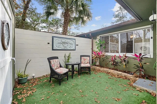 a view of a chairs and table in a backyard