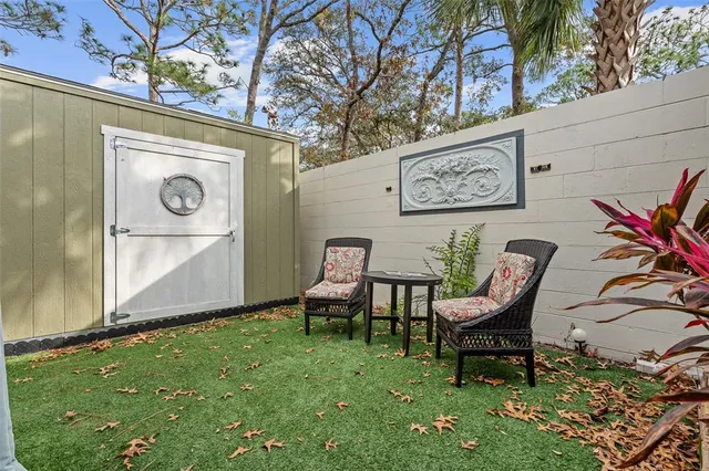 a view of a chairs in backyard of the house