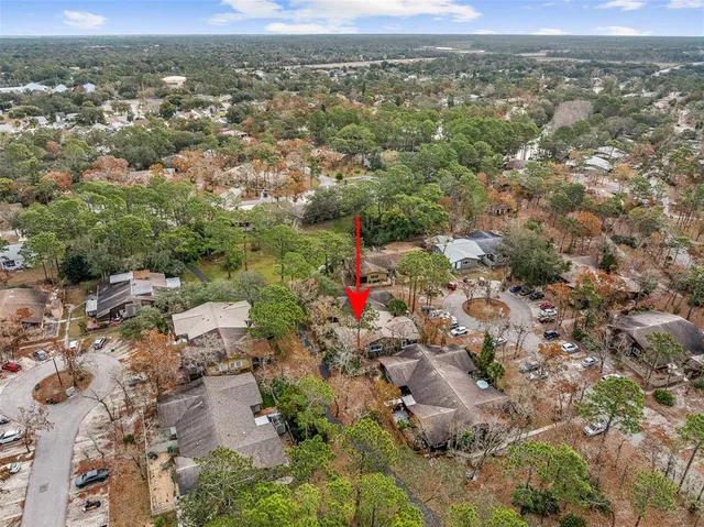 an aerial view of a houses with a yard