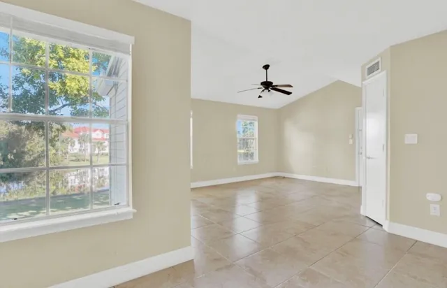 a view of a house with a big yard and potted plants