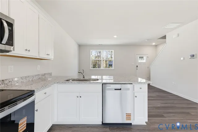 a kitchen with granite countertop a sink and cabinets
