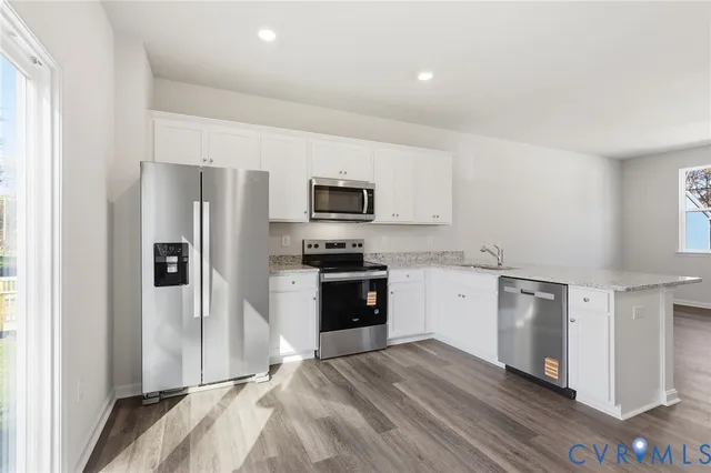 a kitchen with a refrigerator stove and sink