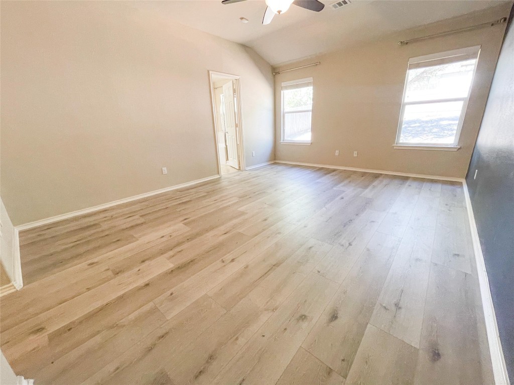2401 Christoff Loop Austin, TX 78748 - Photo 24 of 36 an empty room with wooden floor and windows