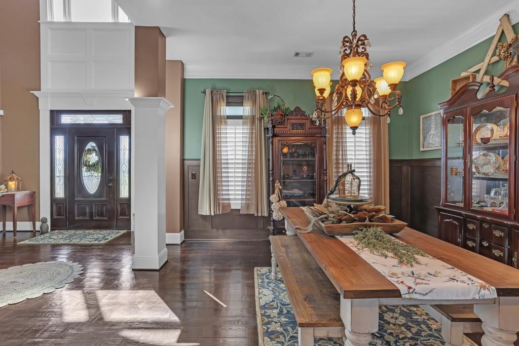3386 Chandler Road Good Hope, GA 30641 - Photo 13 of 96 a view of a dining room with furniture a chandelier and wooden floor