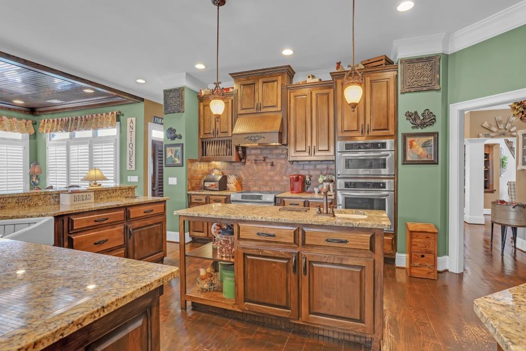 3386 Chandler Road Good Hope, GA 30641 - Photo 21 of 96 a kitchen with stainless steel appliances kitchen island granite countertop a stove a sink and a refrigerator