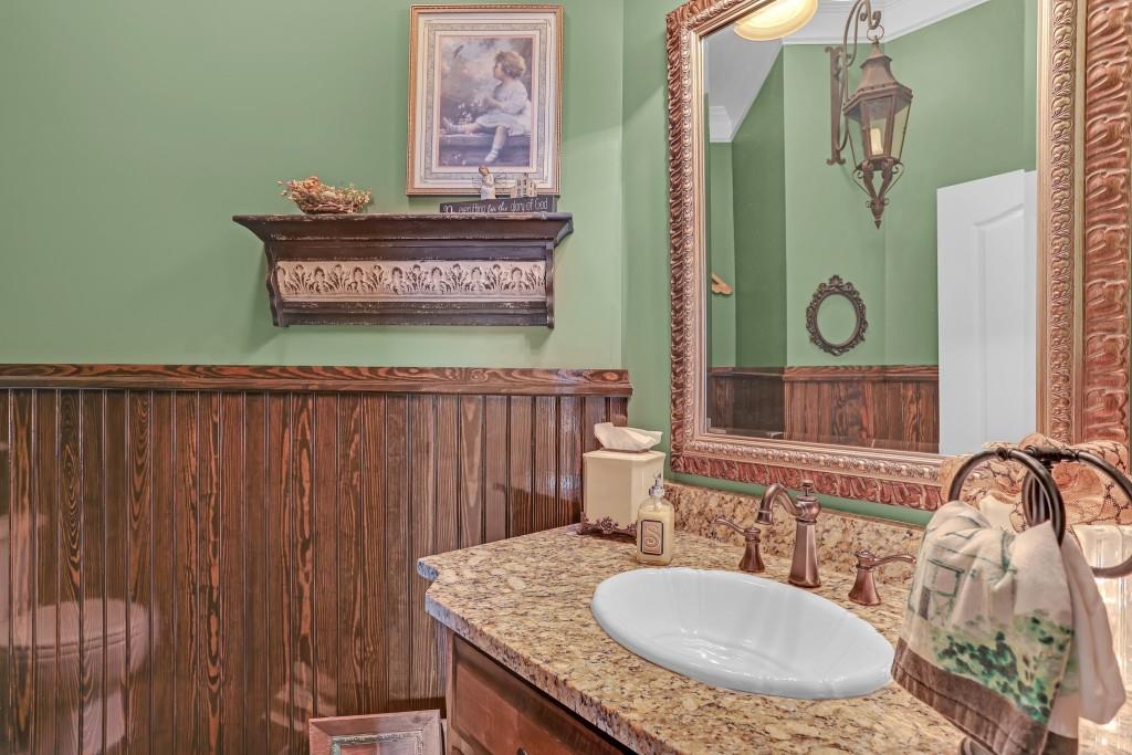 3386 Chandler Road Good Hope, GA 30641 - Photo 33 of 96 a bathroom with a granite countertop sink a mirror and vanity