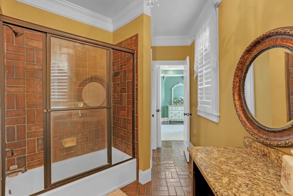 3386 Chandler Road Good Hope, GA 30641 - Photo 39 of 96 a bathroom with a granite countertop shower a mirror and a sink