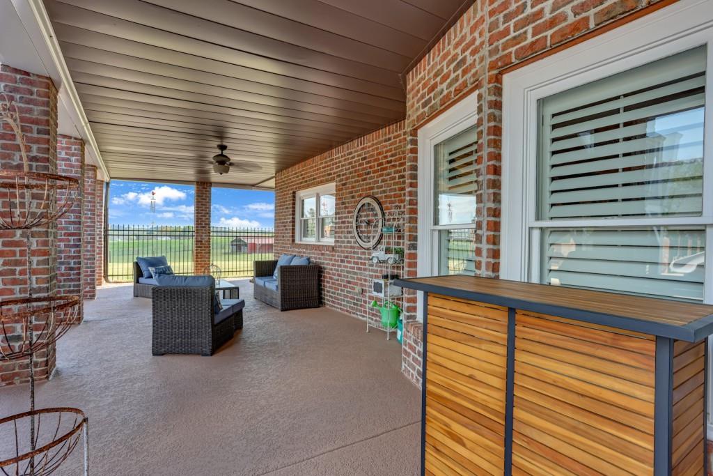 3386 Chandler Road Good Hope, GA 30641 - Photo 61 of 96 a view of a patio with couches chairs potted plants and floor to ceiling window