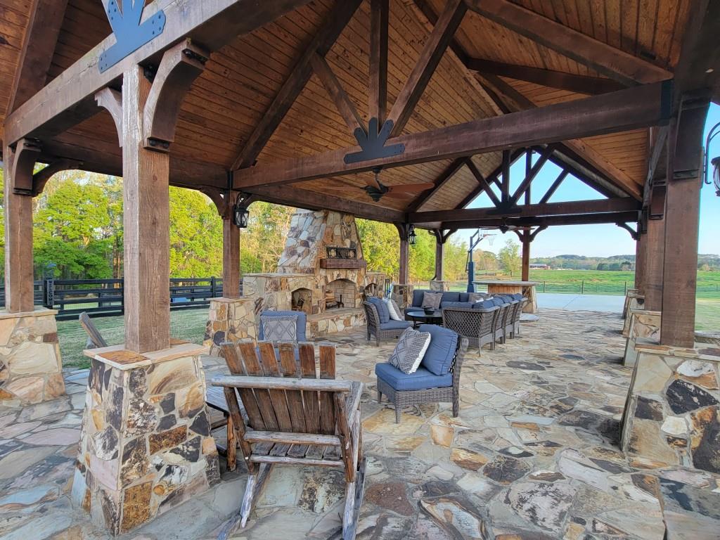 3386 Chandler Road Good Hope, GA 30641 - Photo 74 of 96 a view of a patio with table and chairs under an umbrella with a small yard