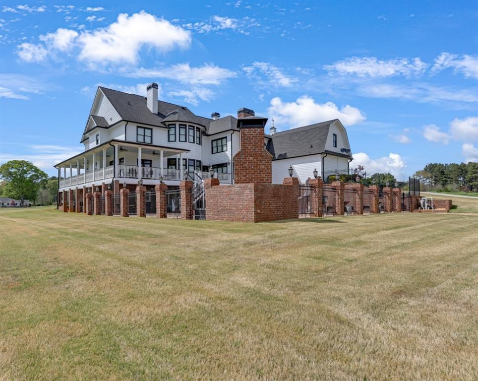 3386 Chandler Road Good Hope, GA 30641 - Photo 9 of 96 a view of a big house with a big yard and large trees