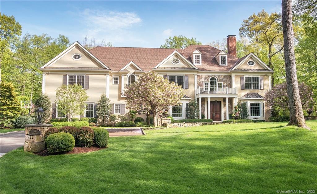28 Eustis Lane Ridgefield, CT 06877 - Photo 1 of 1 a front view of a house with a yard and trees