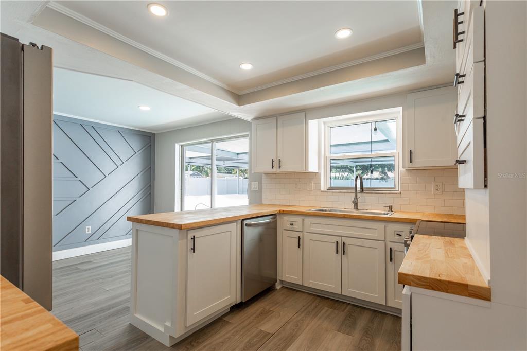 2021 Valley Drive Dunedin, FL 34698 - Photo 15 of 79 a kitchen with a sink stove and cabinets