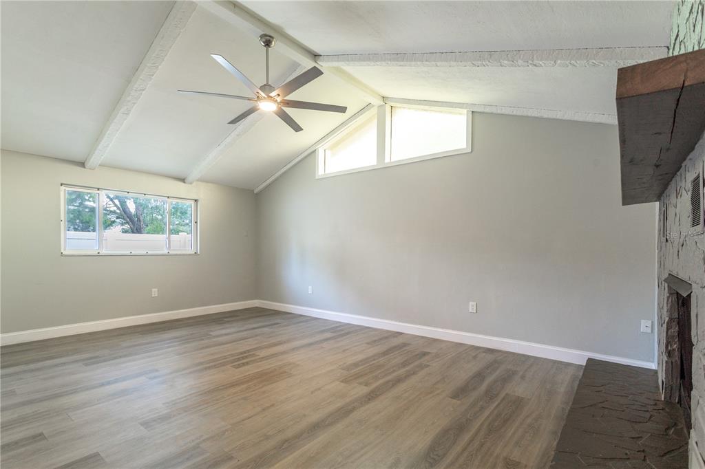 2021 Valley Drive Dunedin, FL 34698 - Photo 18 of 79 a view of an empty room with wooden floor and a window