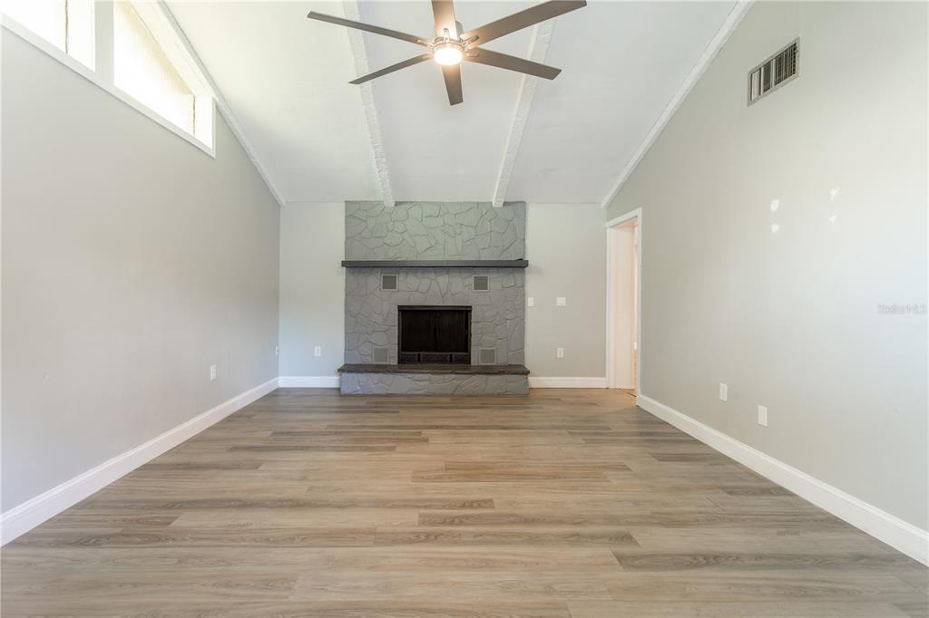 2021 Valley Drive Dunedin, FL 34698 - Photo 19 of 79 a view of an empty room with wooden floor and a window