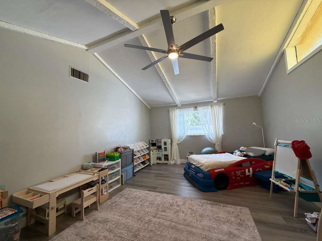 2021 Valley Drive Dunedin, FL 34698 - Photo 22 of 79 a bedroom with furniture and a window