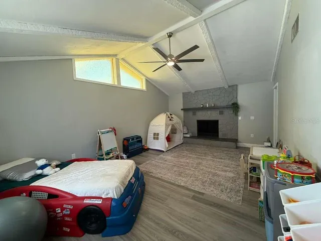 a bedroom with a bed and a night stand