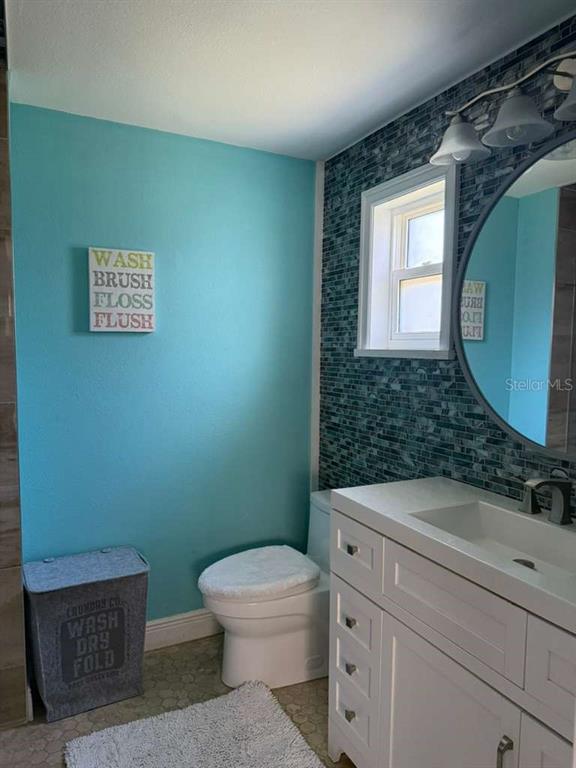 2021 Valley Drive Dunedin, FL 34698 - Photo 25 of 79 a bathroom with a toilet sink and mirror