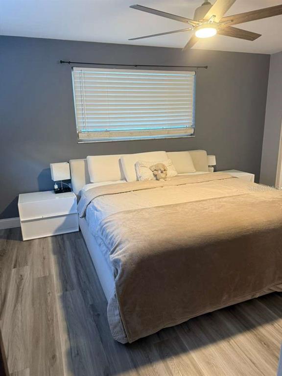 2021 Valley Drive Dunedin, FL 34698 - Photo 32 of 79 a bedroom with a bed and a night stand