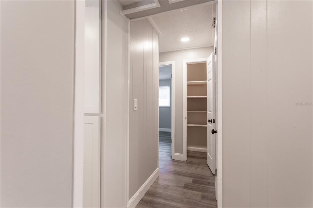 2021 Valley Drive Dunedin, FL 34698 - Photo 33 of 79 a view of a hallway with wooden floor and closet