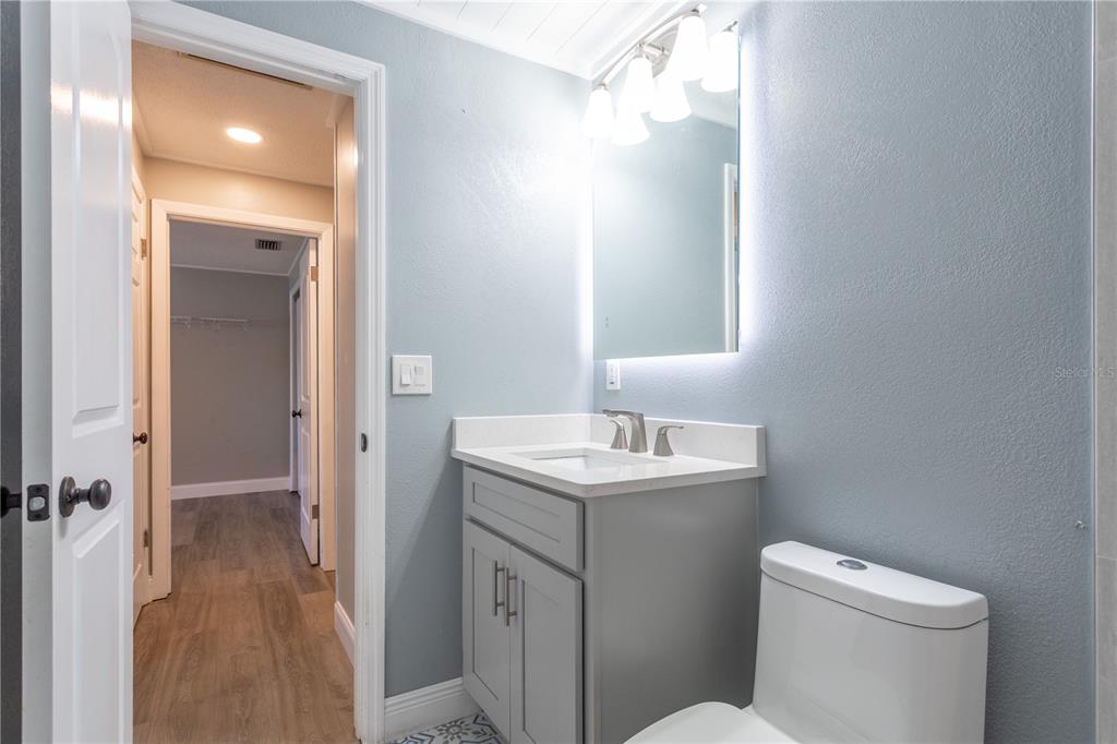 2021 Valley Drive Dunedin, FL 34698 - Photo 35 of 79 a bathroom with a toilet a sink and mirror