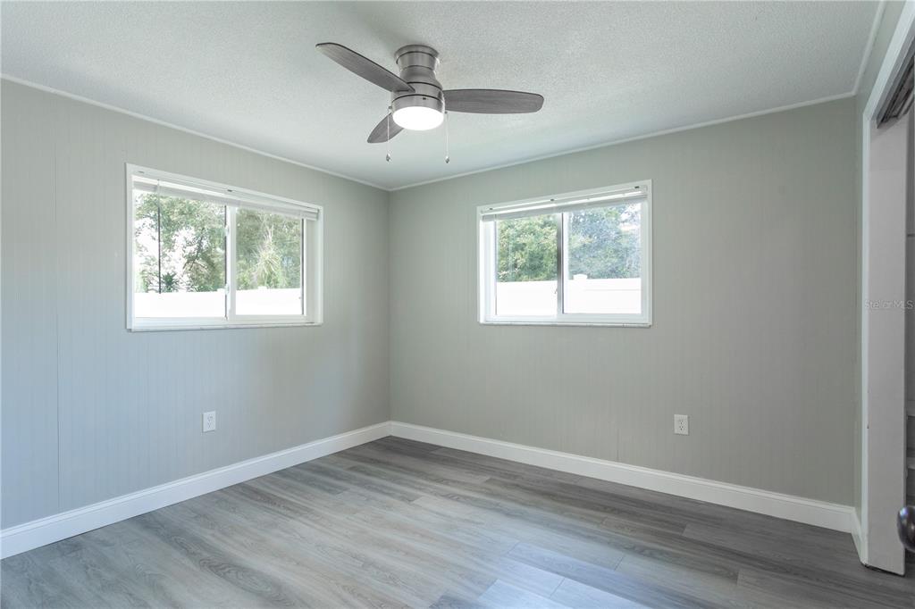 2021 Valley Drive Dunedin, FL 34698 - Photo 38 of 79 a view of empty room with wooden floor and fan