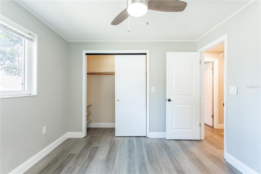 2021 Valley Drive Dunedin, FL 34698 - Photo 39 of 79 a view of an empty room with wooden floor and a window