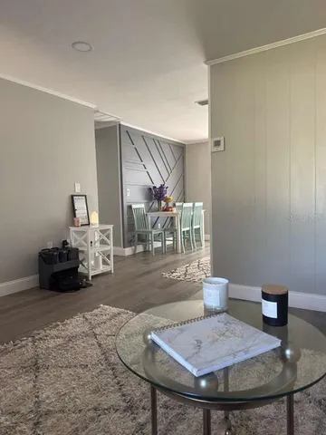 a view of a dining room with furniture and wooden floor