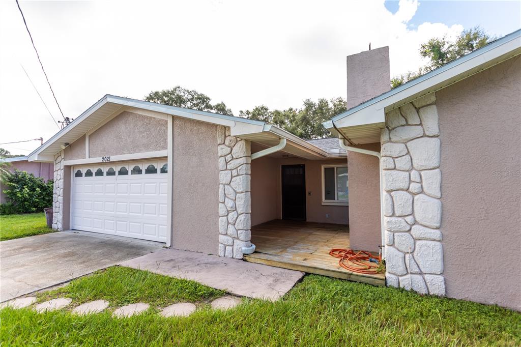 2021 Valley Drive Dunedin, FL 34698 - Photo 45 of 79 a view of a house with a yard and garage