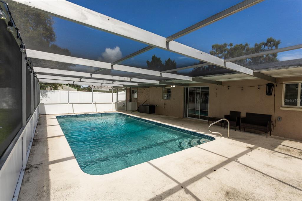 2021 Valley Drive Dunedin, FL 34698 - Photo 54 of 79 a view of a backyard with table and chairs