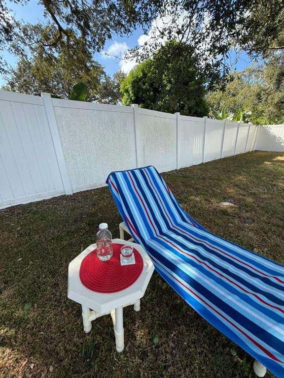 2021 Valley Drive Dunedin, FL 34698 - Photo 65 of 79 a backyard of a house with table and chairs