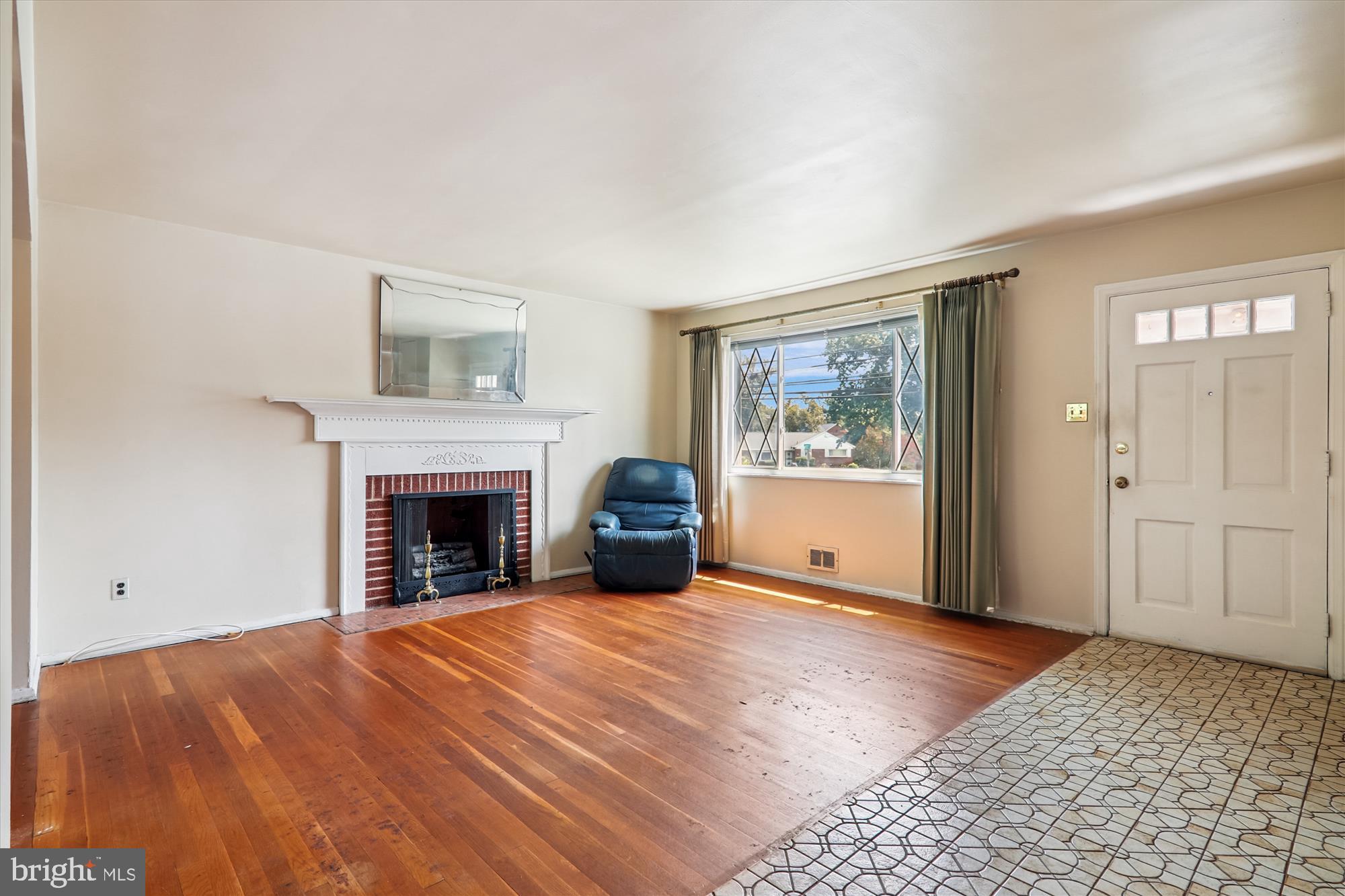 9507 Adelphi Road Silver Spring, MD 20903 - Photo 4 of 41 a view of a livingroom with an empty space and a fireplace