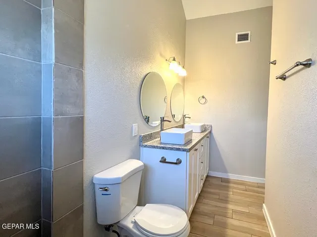 a bathroom with a sink toilet and a mirror