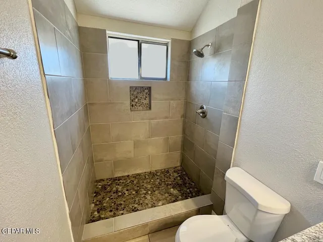 a bathroom with a toilet and shower