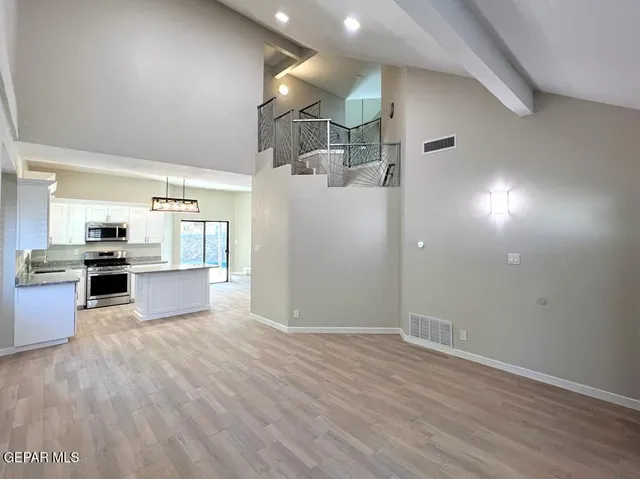 a view of a kitchen with wooden floor