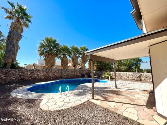 a view of a swimming pool with a patio