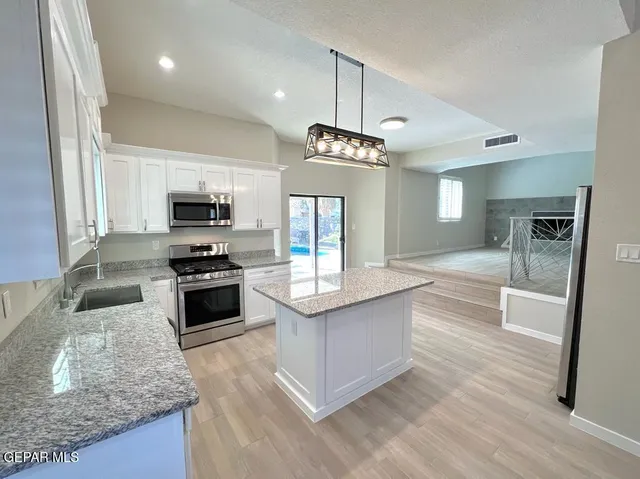 a kitchen with stainless steel appliances granite countertop a stove oven and a sink with granite countertops