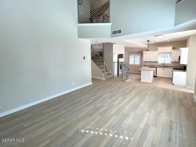 a view of a room with wooden floor