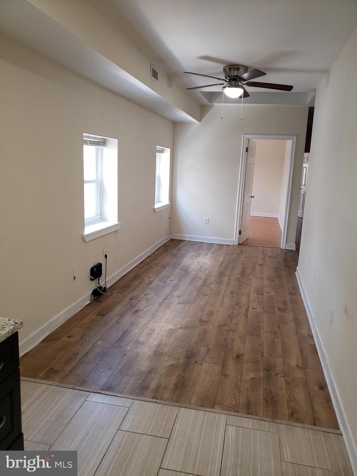 319 Market Street, Unit 3 Philadelphia, PA 19106 - Photo 11 of 14 an empty room with wooden floor and windows