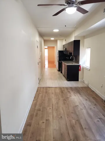 a view of kitchen with microwave and refrigerator