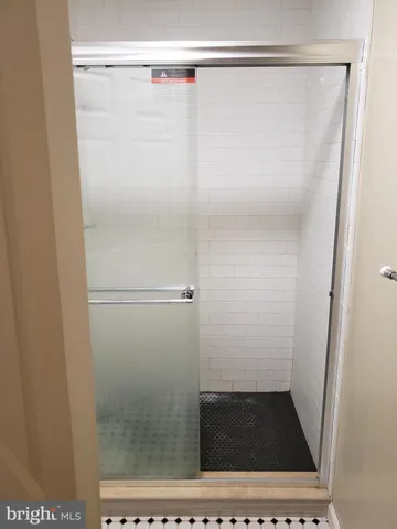 a bathroom with a glass shower door