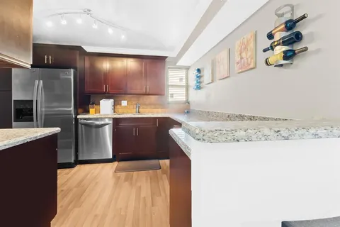 a kitchen with a sink a stove and cabinets