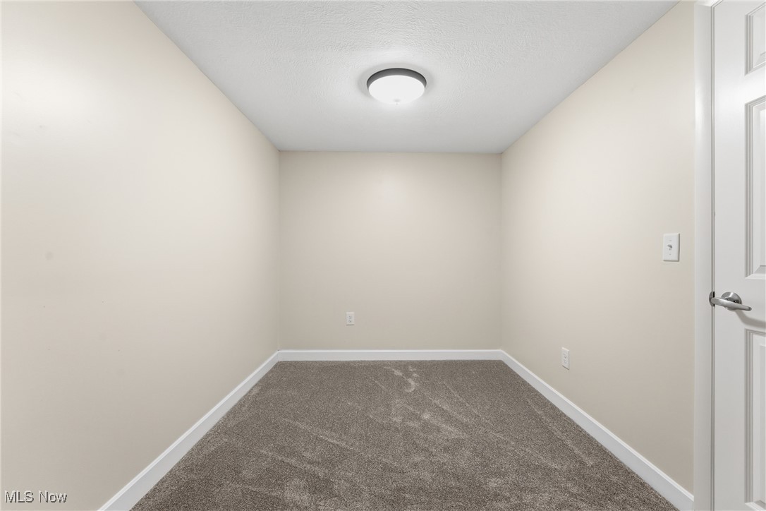 3793 Ranfield Road Kent, OH 44240 - Photo 16 of 40 Storage room with a textured ceiling and dark carpet