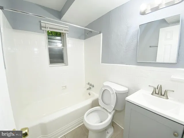 a white toilet sitting next to a bathroom sink