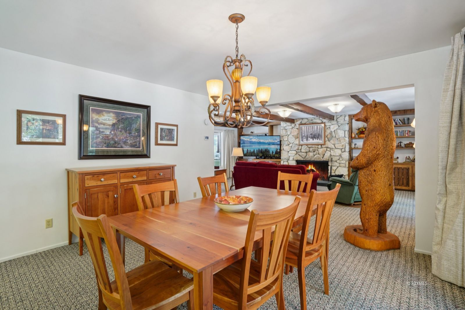 24490 Upper Rim Rock Road Idyllwild, CA 92549 - Photo 16 of 41 a dining room with furniture a chandelier and wooden floor