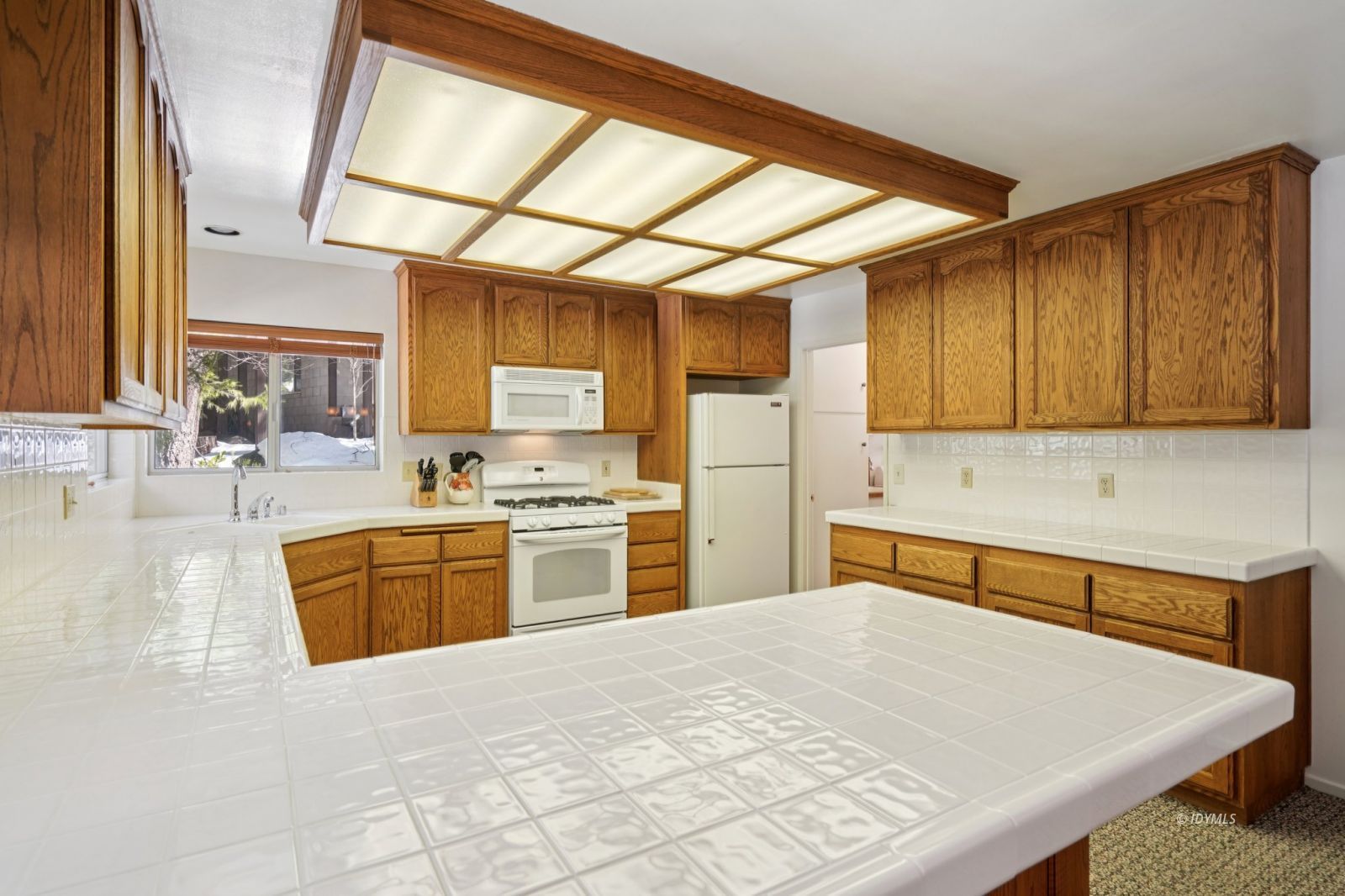 24490 Upper Rim Rock Road Idyllwild, CA 92549 - Photo 18 of 41 a kitchen with stainless steel appliances kitchen island granite countertop a refrigerator a sink dishwasher a stove with wooden cabinets and floor