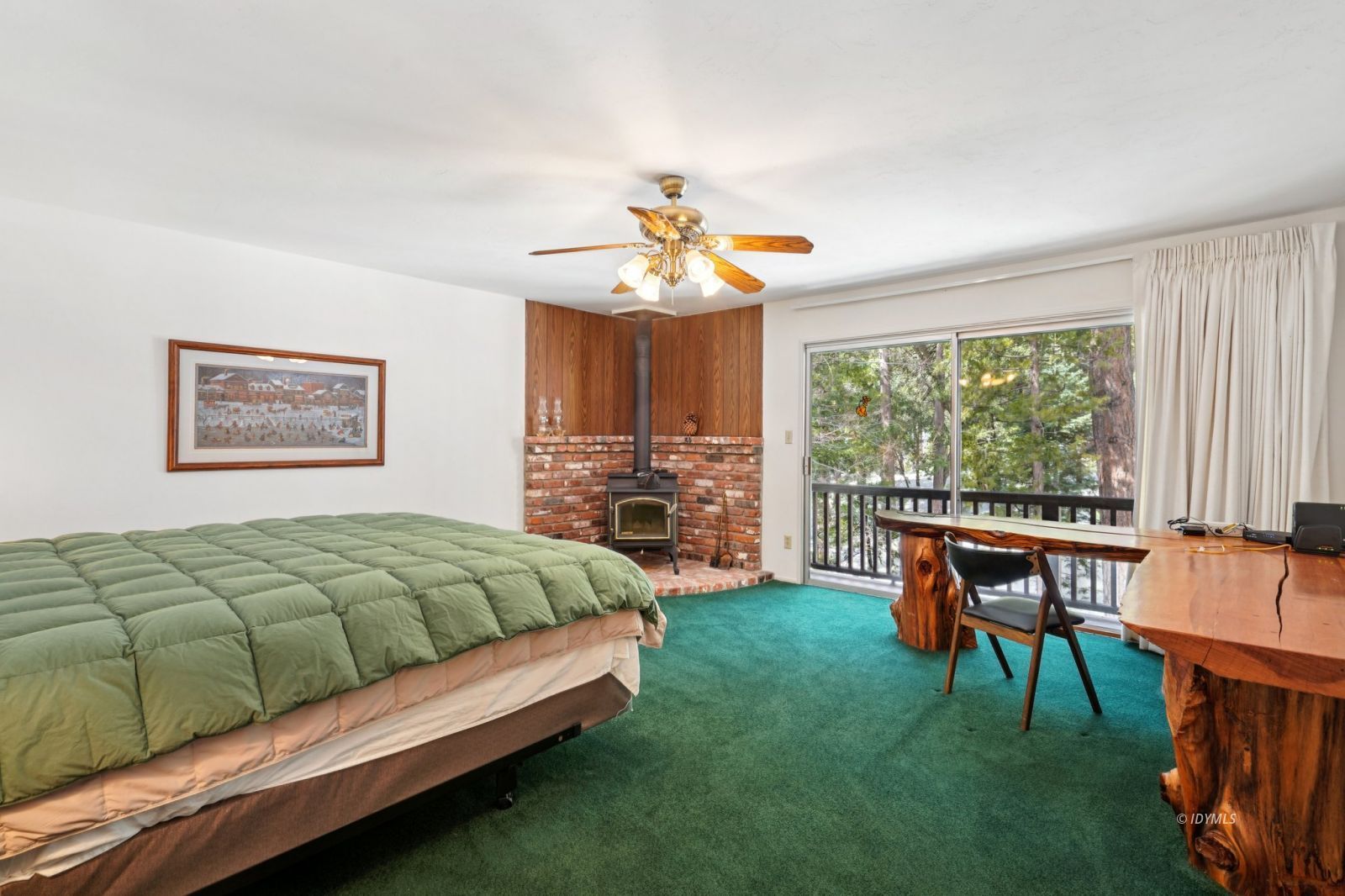 24490 Upper Rim Rock Road Idyllwild, CA 92549 - Photo 24 of 41 a bedroom with a bed and a chandelier